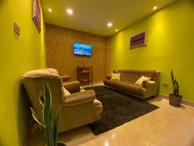 a living room with two couches and a tv at BROTHERs HOUSE in Cusco