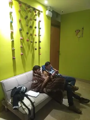 two men sitting on a couch in a room at BROTHERs HOUSE in Cusco