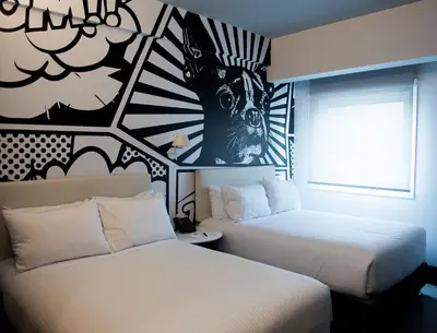 a hotel room with two beds and a window at Radisson RED Miraflores in Lima