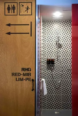 a bathroom with a shower with a sign on the door at Radisson RED Miraflores in Lima