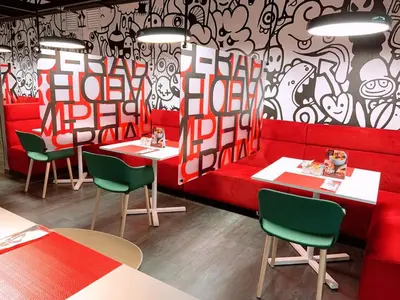 a restaurant with red tables and green chairs at Radisson RED Miraflores in Lima