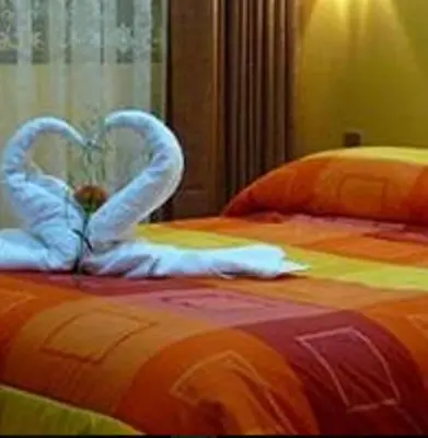 a bed with two swans made to look like hearts at Hotel Inkayra in Cusco
