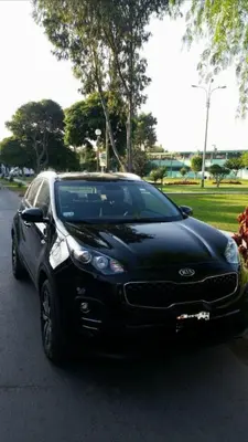 a black car parked on a street next to a park at CASA LOPEZ in Lima