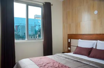 a bedroom with a bed with a large window at Martinika in Lima