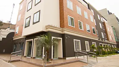 a large building with palm trees in front of it at Martinika in Lima