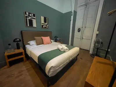 a bedroom with a large bed with white sheets at Viajero Lima - Barranco Hostel in Lima