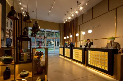a lobby of a store with people sitting at a counter at Casa Andina Premium San Isidro in Lima
