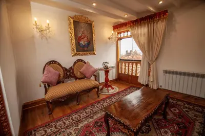 a living room with two chairs and a table and a window at Casona Corrales Hotel Boutique in Cusco