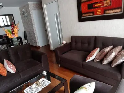 a living room with a brown couch and pillows at Hope San Isidro in Lima