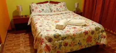 a bedroom with a bed with two towels on it at Marlon's House Nasca in Nazca