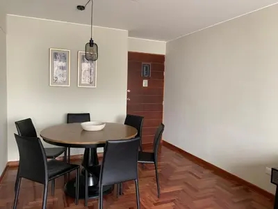 a dining room with a table and chairs at MLA Apartments - Alcanfores in Lima