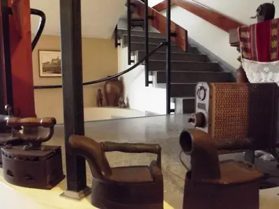 a room with a table with a chair and stairs at Hostal Gemina in Lima
