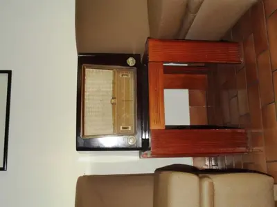 a mirror on a wall next to a couch at Hostal Gemina in Lima
