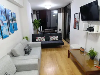 a living room with a couch and a tv at Pet Friendly Apart-Maximo 9 Personas-Piscina-Parrilla-Billar-Gimnasio in Lima