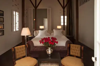 a hotel room with a bed with red flowers on it at Hotel B in Lima