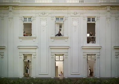a white building with a man on a balcony at Hotel B in Lima
