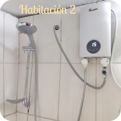 a shower head in a bathroom with a shower at Munay San Blas Wasi in Cusco