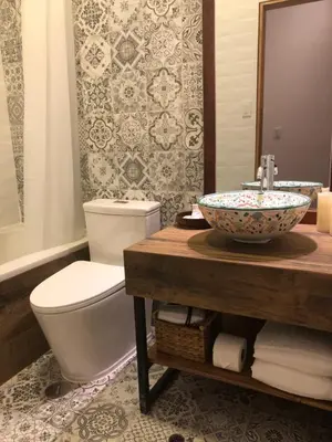 a bathroom with a toilet and a bowl sink at Casa Biru Hotel Boutique in Cusco