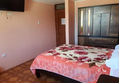a bedroom with a bed and a dresser at La Azotea in Huancayo