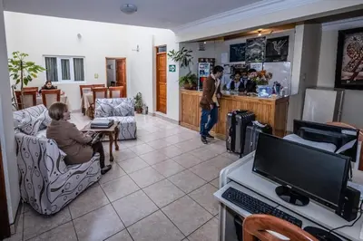 a woman sitting in a chair in a room at Hostal El Peregrino in Cusco