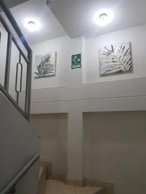 a hallway with three pictures on the wall at Hostal refugio's in Ica