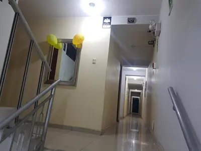 a hallway with stairs and a mirror and yellow balloons at Hostal refugio's in Ica