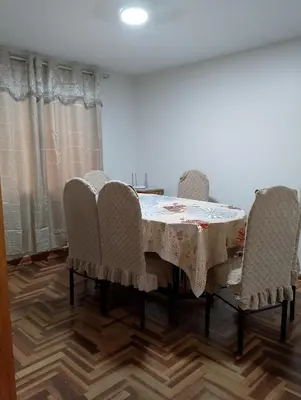 a dining room with a table and four chairs at MUNAYCHA`S WASI in Cusco