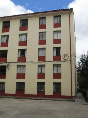 an apartment building with red and white at MUNAYCHA`S WASI in Cusco
