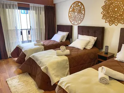a hotel room with two beds and a window at Apartamento a pasos de la Plaza Cusco Inlove in Cusco