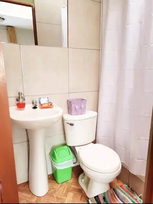a bathroom with a toilet and a sink at wayra house san blas in Cusco