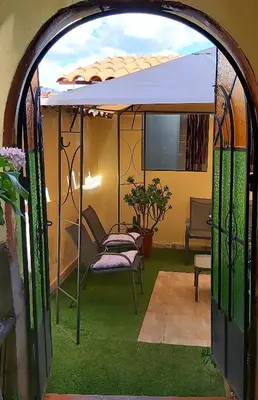 an archway with a chair under an umbrella at wayra house san blas in Cusco