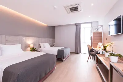 a hotel room with two beds and a desk at Surya Lima in Lima