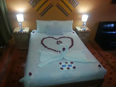 a bed with a heart made out of pillows at Kurumi Hostel in Cusco