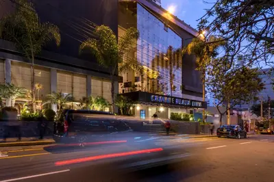 a van driving down a street in front of a building at Crowne Plaza Lima by IHG in Lima
