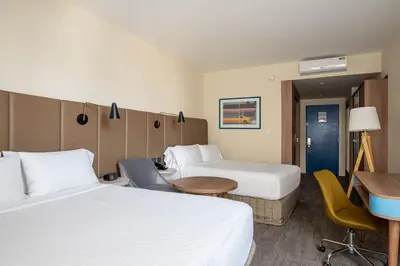 a hotel room with two beds and a desk at Crowne Plaza Lima by IHG in Lima