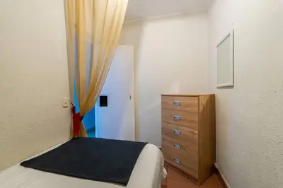 a bedroom with a bed and a wooden dresser at Británico en Miraflores & primer piso, 3 dormitorios in Lima