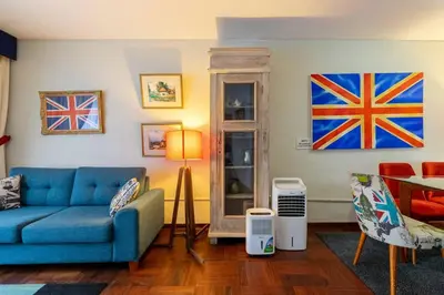 a living room with a blue couch and flags on the wall at Británico en Miraflores & primer piso, 3 dormitorios in Lima