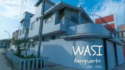 a white building with the words wasergop at B&B Wasi Airport Lima in Lima