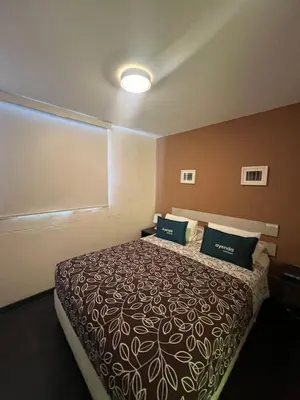 a bedroom with a bed with two pillows on it at B&B Wasi Airport Lima in Lima