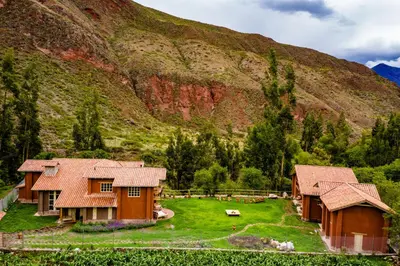 a group of houses in front of a mountain at NUNA by DCO in Urubamba