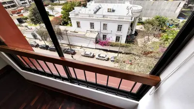 a window with a view of a white building at Hermoso departamento en el Corazón de Miraflores in Lima