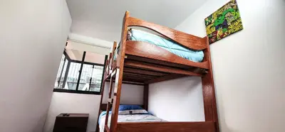 a bunk bed in a room with a ladder at Hermoso departamento en el Corazón de Miraflores in Lima