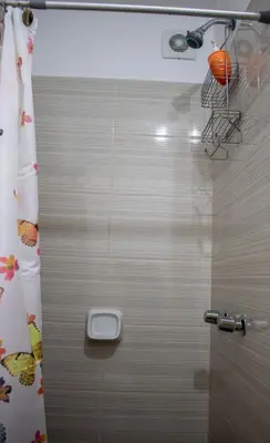 a bathroom with a shower with a door with a toilet at Departamento 100 m2 con luz natural y Seguridad 24h in Lima