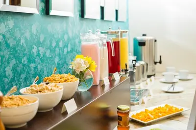 a buffet line with bowls of food and drinks at SACHA Centric in Cusco
