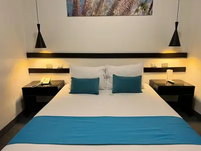 a bedroom with a large bed with two night stands at SACHA Centric in Cusco