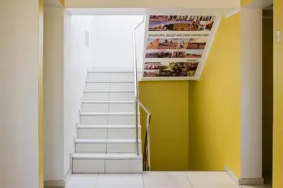 a staircase in a house with a magazine on the wall at ica wasi hostel in Ica