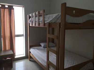 two bunk beds in a room with a window at DEPARTAMENTO SAN BARTOLO-2dormitorios in Lima