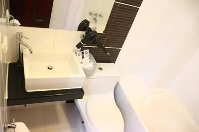 a bathroom with a sink and a toilet at Fenix Hotel Machupicchu in Machu Picchu