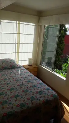 a bedroom with a bed and a window at Garden House Miraflores in Lima