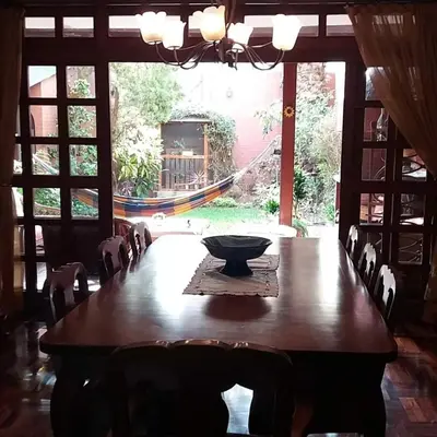 a dining room table with chairs and a bowl on it at Garden House Miraflores in Lima